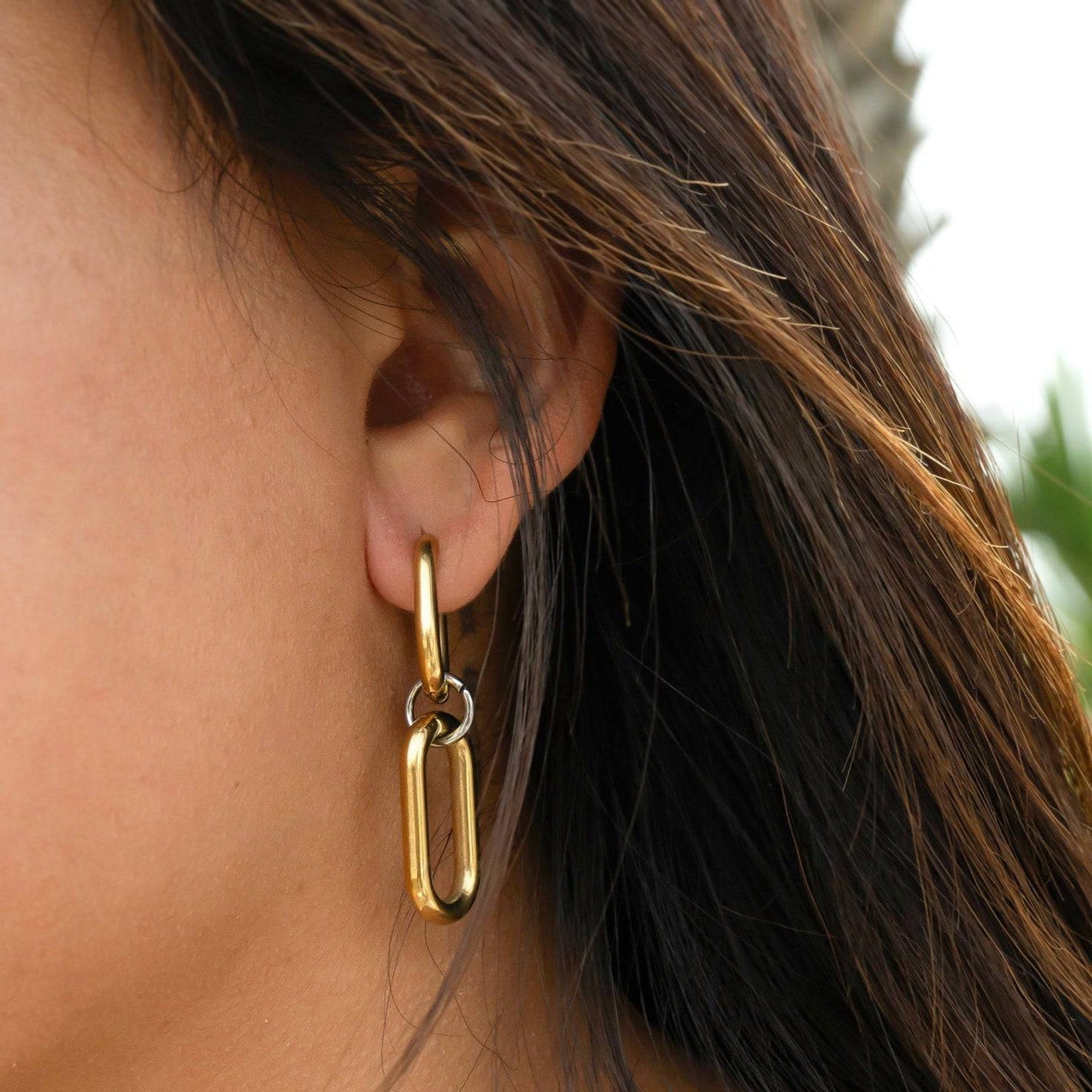 Close-up of gold convertible huggie dangle earrings worn on ear – waterproof, tarnish-free, and hypoallergenic from Lauren Riley Jewelry