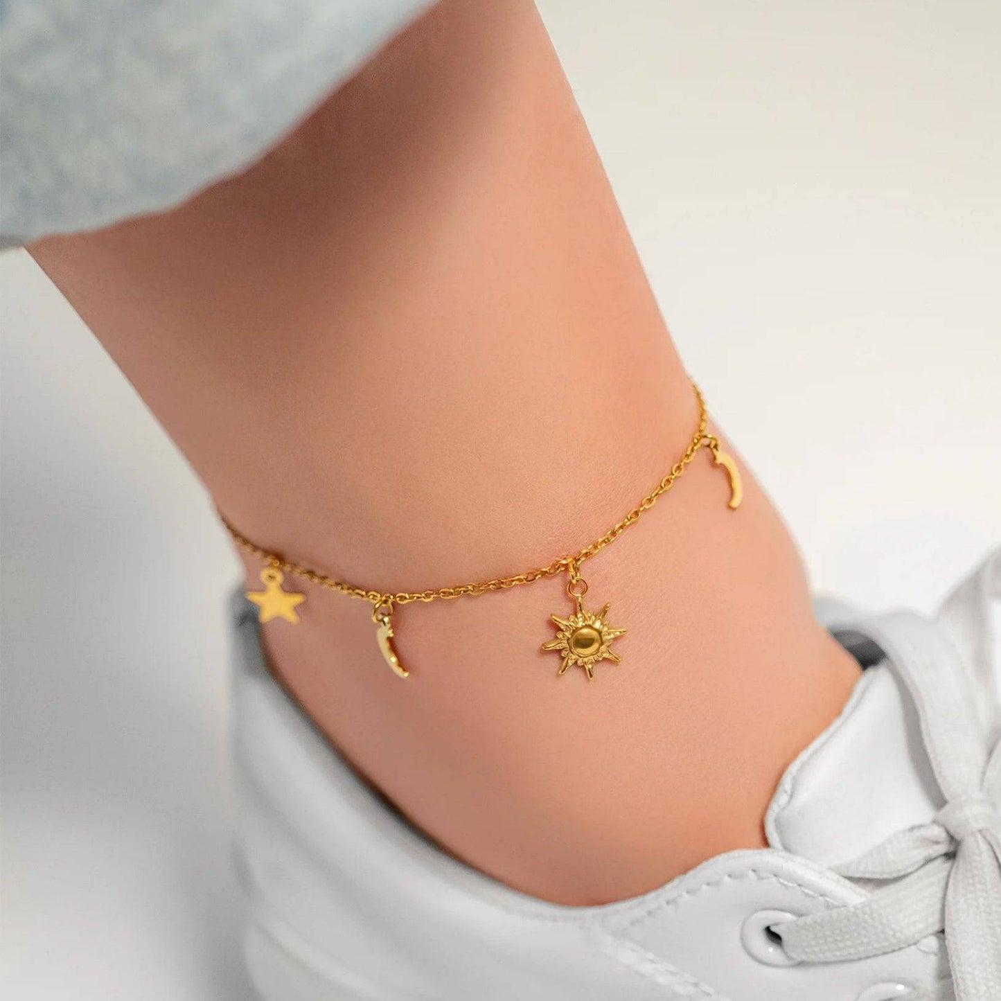Gold celestial charm anklet with sun, moon, and star pendants – stylish ankle bracelet for women, perfect for everyday wear, beach outfits, and summer fashion
