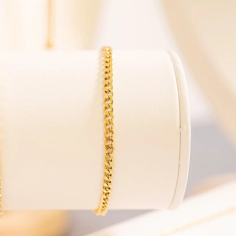 Elegant gold Cuban link bracelet on display — 18k PVD gold over stainless steel, hypoallergenic and waterproof.