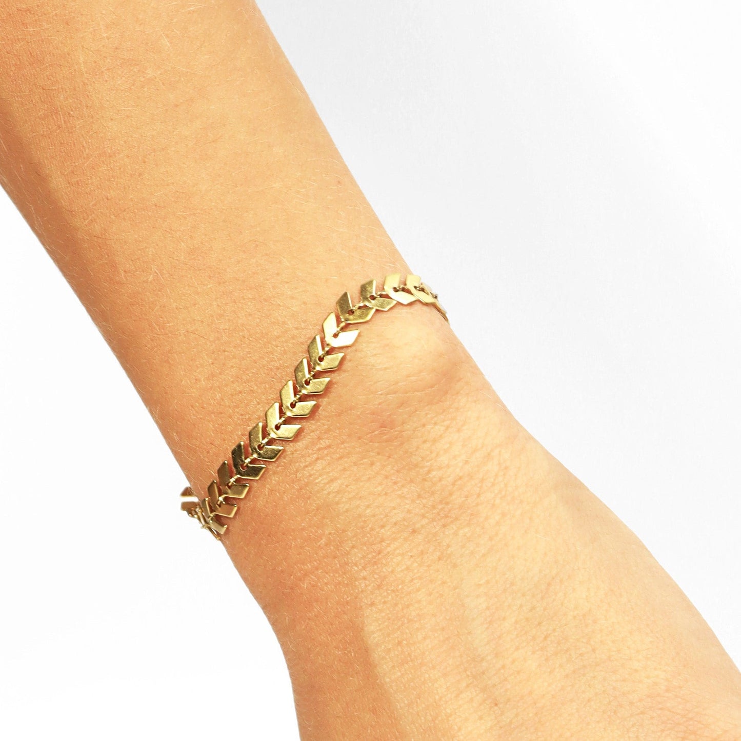 Gold chevron bracelet on wrist showcasing delicate and dainty everyday style