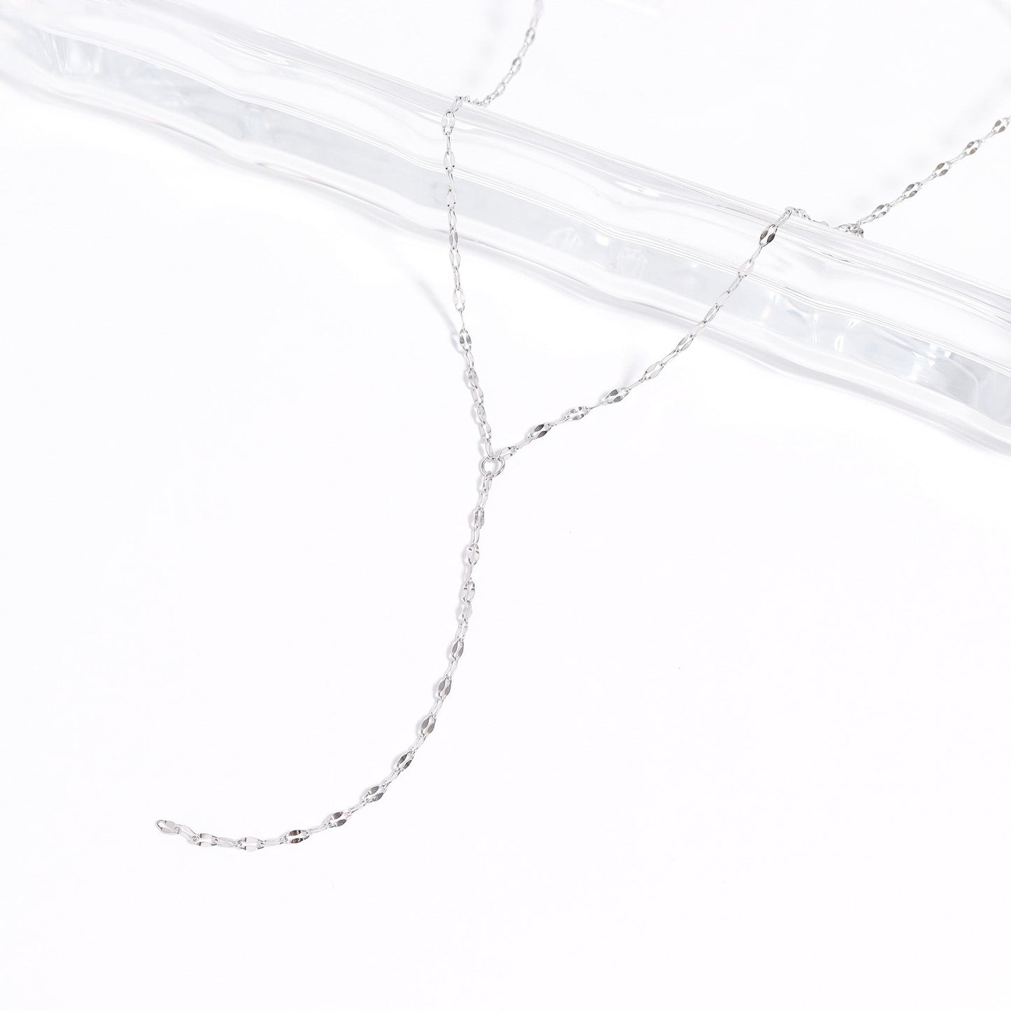 Dainty silver Y-lariat necklace on a white background – waterproof and hypoallergenic stainless steel chain with minimalist design, perfect for layering or everyday wear.