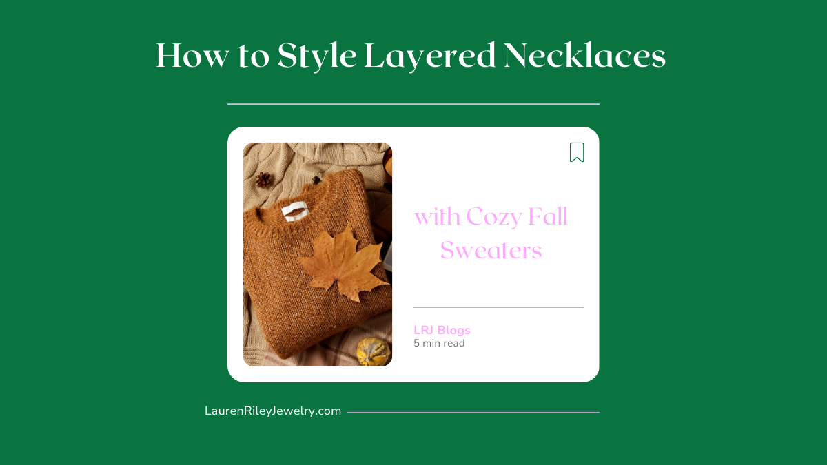 Flatlay of a cozy brown fall sweater with a maple leaf on top promoting Lauren Riley Jewelry’s blog on how to style layered necklaces with fall outfits.