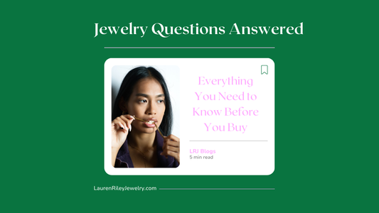 Woman examining gold necklace with thoughtful expression – jewelry FAQs and buying guide by Lauren Riley Jewelry
