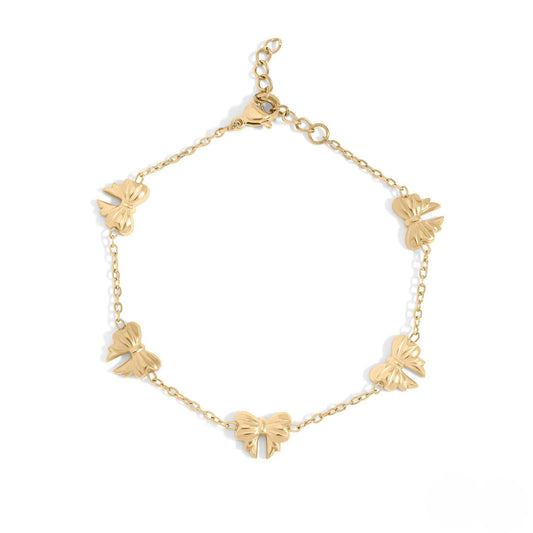 Gold bow charm bracelet made of waterproof, hypoallergenic 18k gold PVD stainless steel with dainty chain design – elegant and tarnish-resistant.