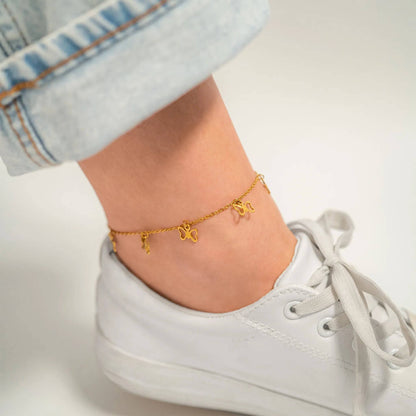 Gold butterfly charm anklet for women – waterproof PVD ankle bracelet styled with sneakers, perfect for summer outfits and beach days