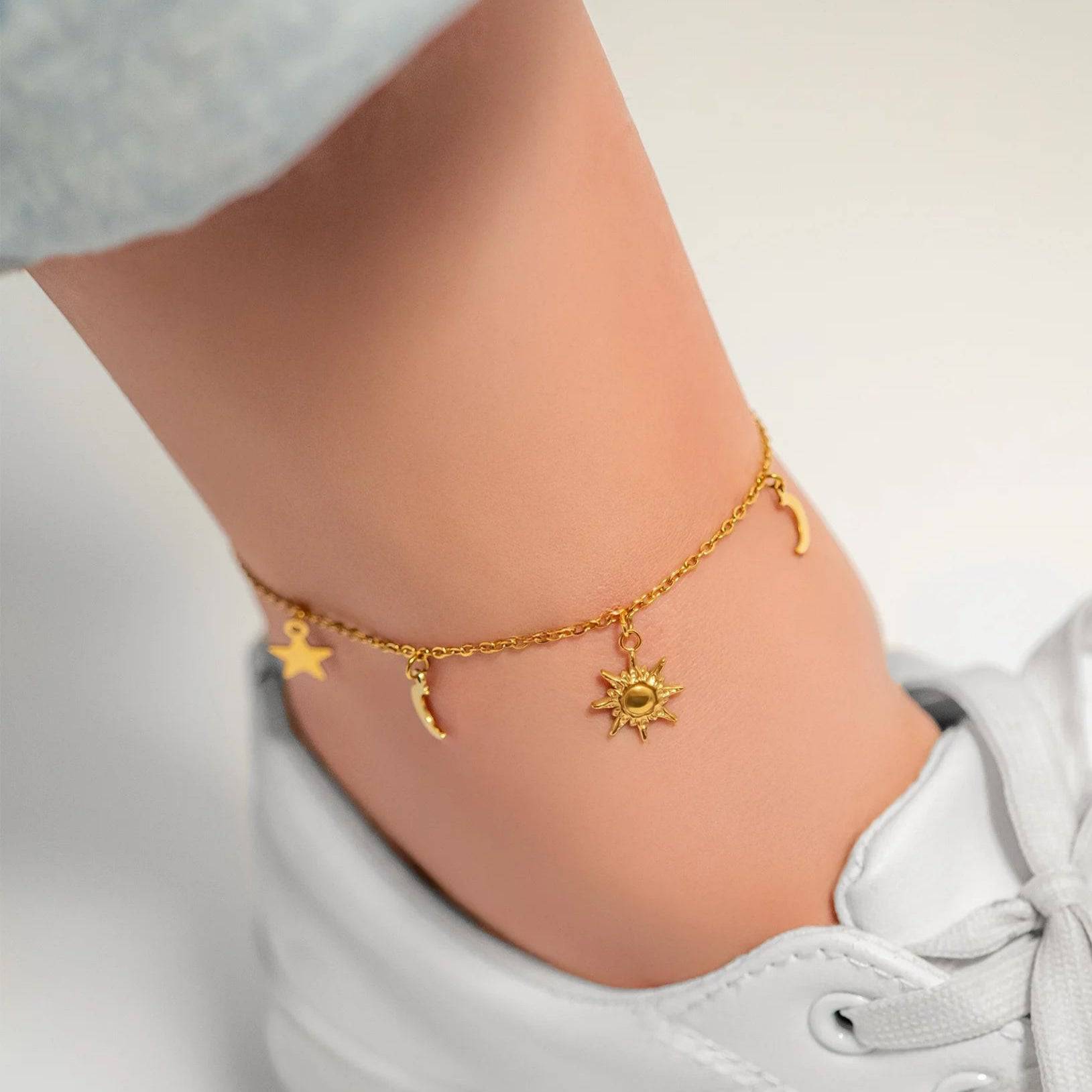 Gold celestial charm anklet with sun, moon, and star pendants – stylish ankle bracelet for women, perfect for everyday wear, beach outfits, and summer fashion