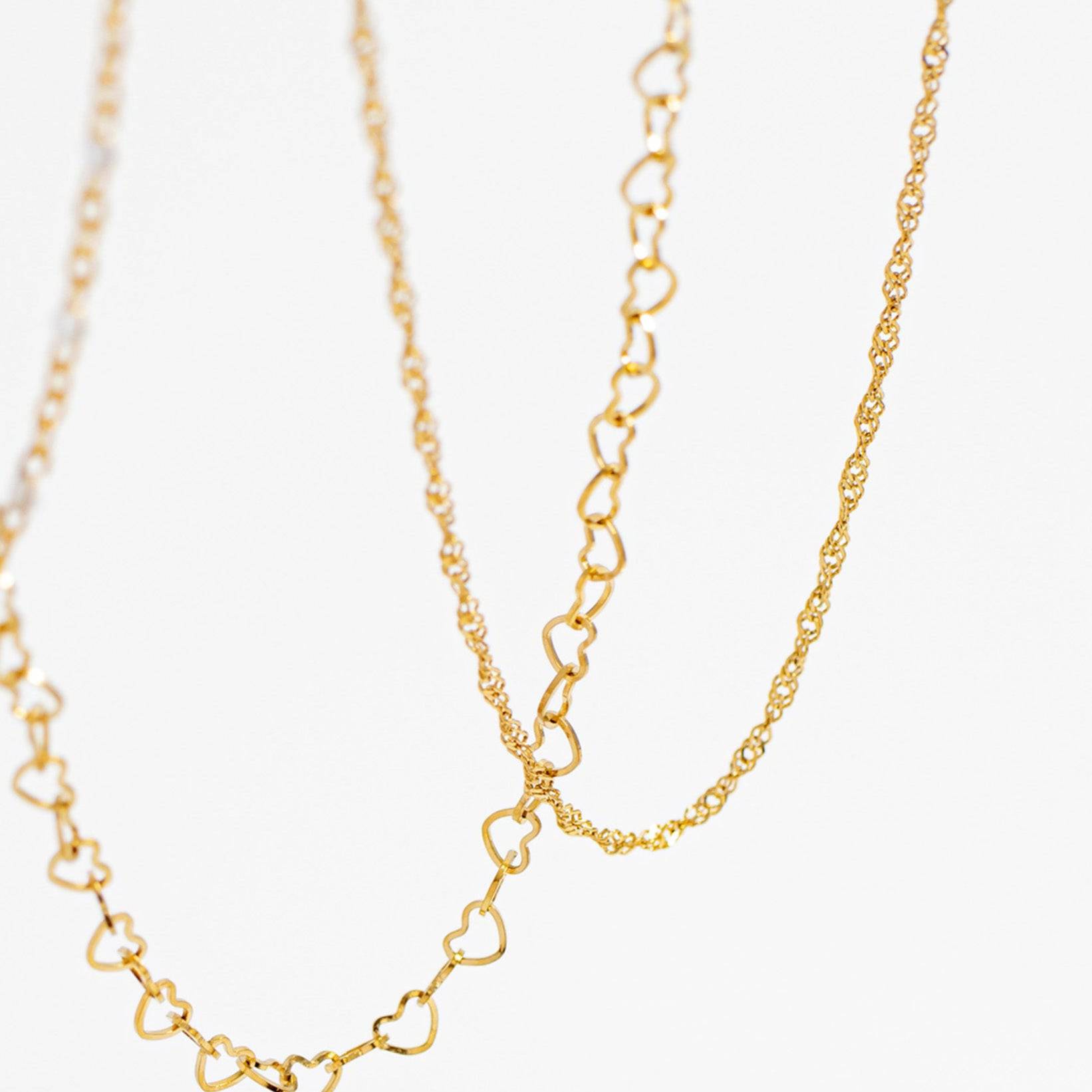 Close-up of gold heart chain and Singapore chain necklaces – waterproof, tarnish-free, and hypoallergenic jewelry by Lauren Riley Jewelry