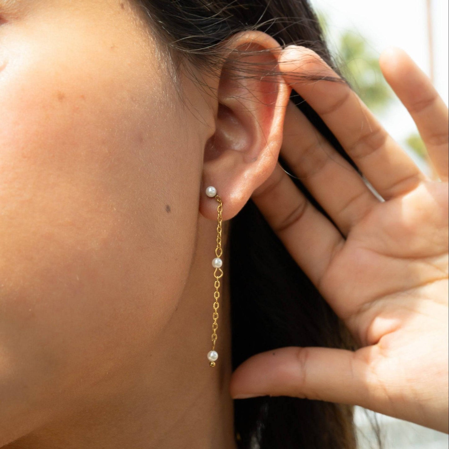 Model wearing dainty gold chain drop earrings with pearl accents – elegant and lightweight hypoallergenic jewelry for everyday or special occasions