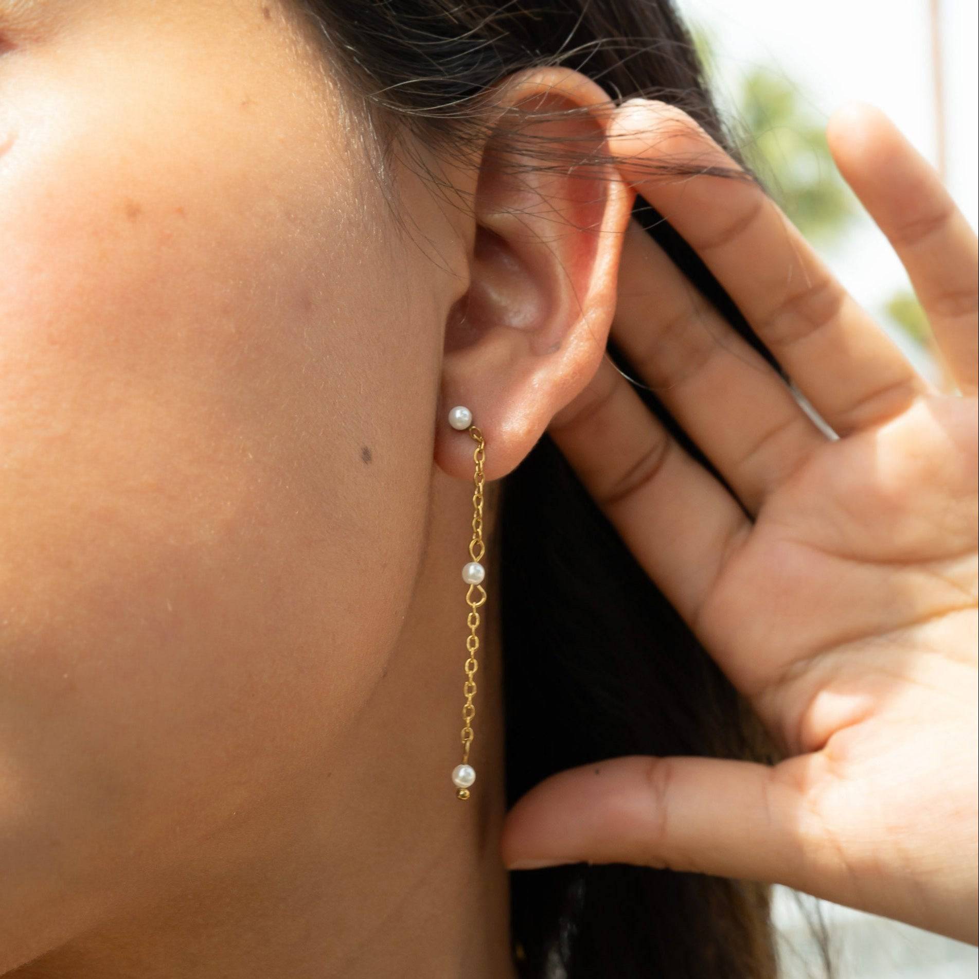 Model wearing dainty gold chain drop earrings with pearl accents – elegant and lightweight hypoallergenic jewelry for everyday or special occasions