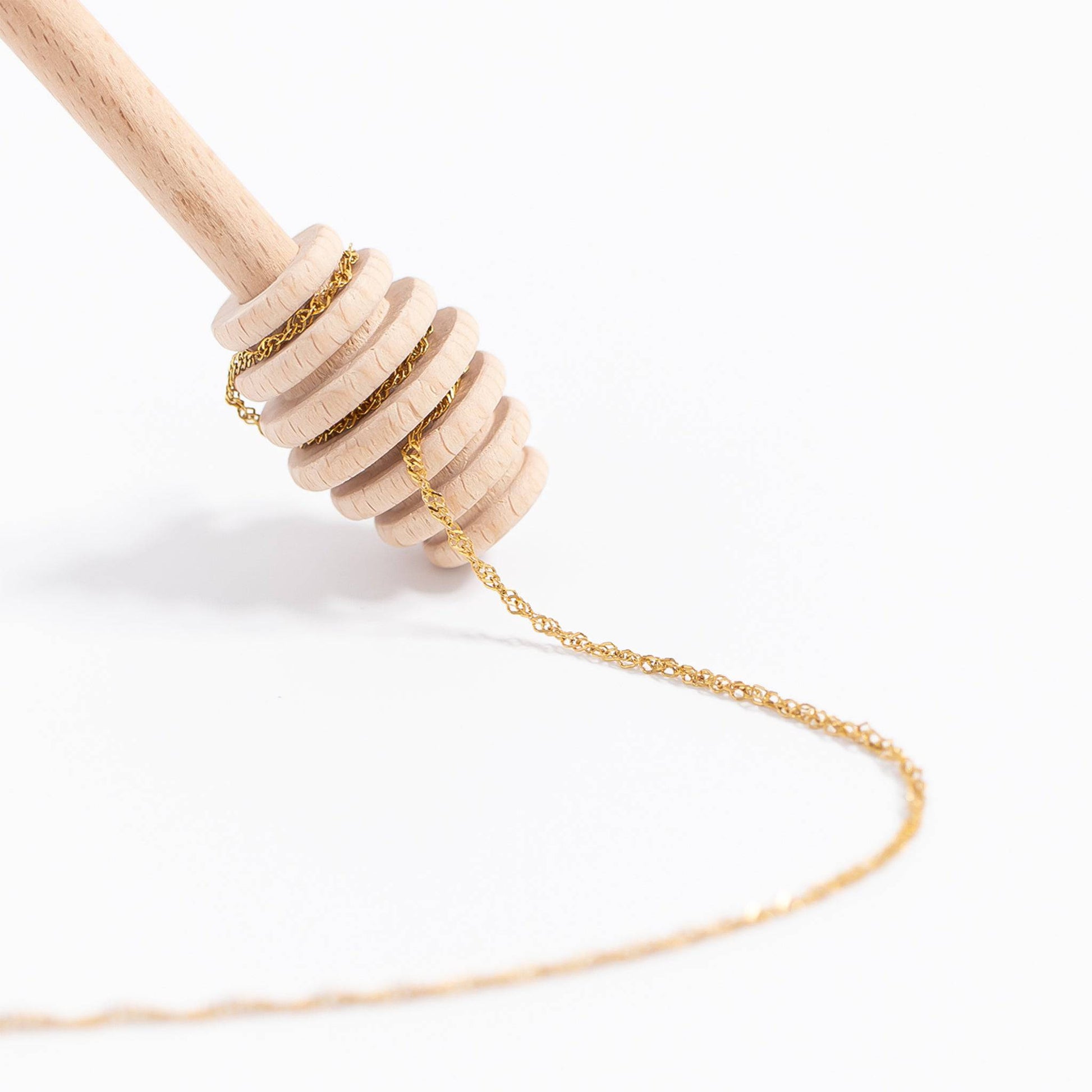 Gold Singapore chain necklace wrapped around honey dipper – elegant waterproof jewelry by Lauren Riley Jewelry