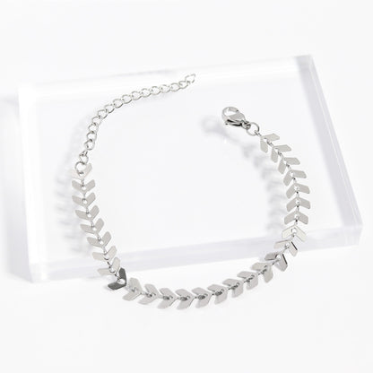 Silver stainless steel herringbone bracelet on acrylic stand - elegant and waterproof design