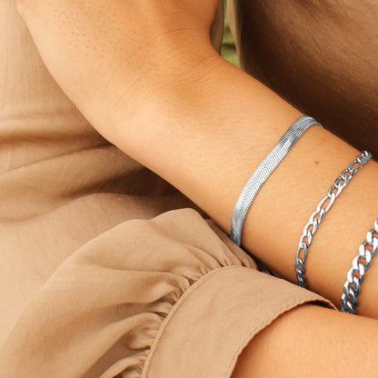 Minimalist silver herringbone bracelet stacked with link bracelet – beach-safe jewelry from Lauren Riley Jewelry.