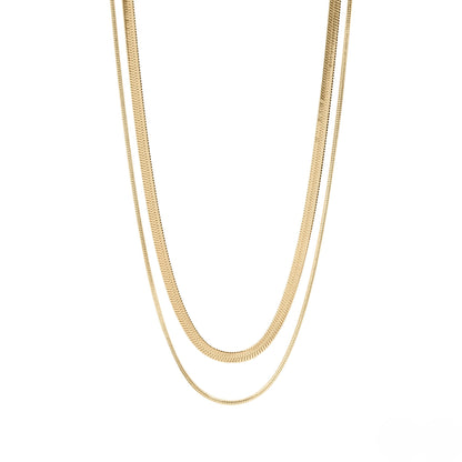 Gold layered herringbone necklace flatlay showcasing waterproof stainless steel chains in two lengths