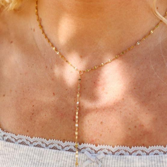 Gold Y-lariat necklace on model – dainty waterproof and tarnish-resistant stainless steel chain with delicate drop detail, ideal for layering and everyday elegance.