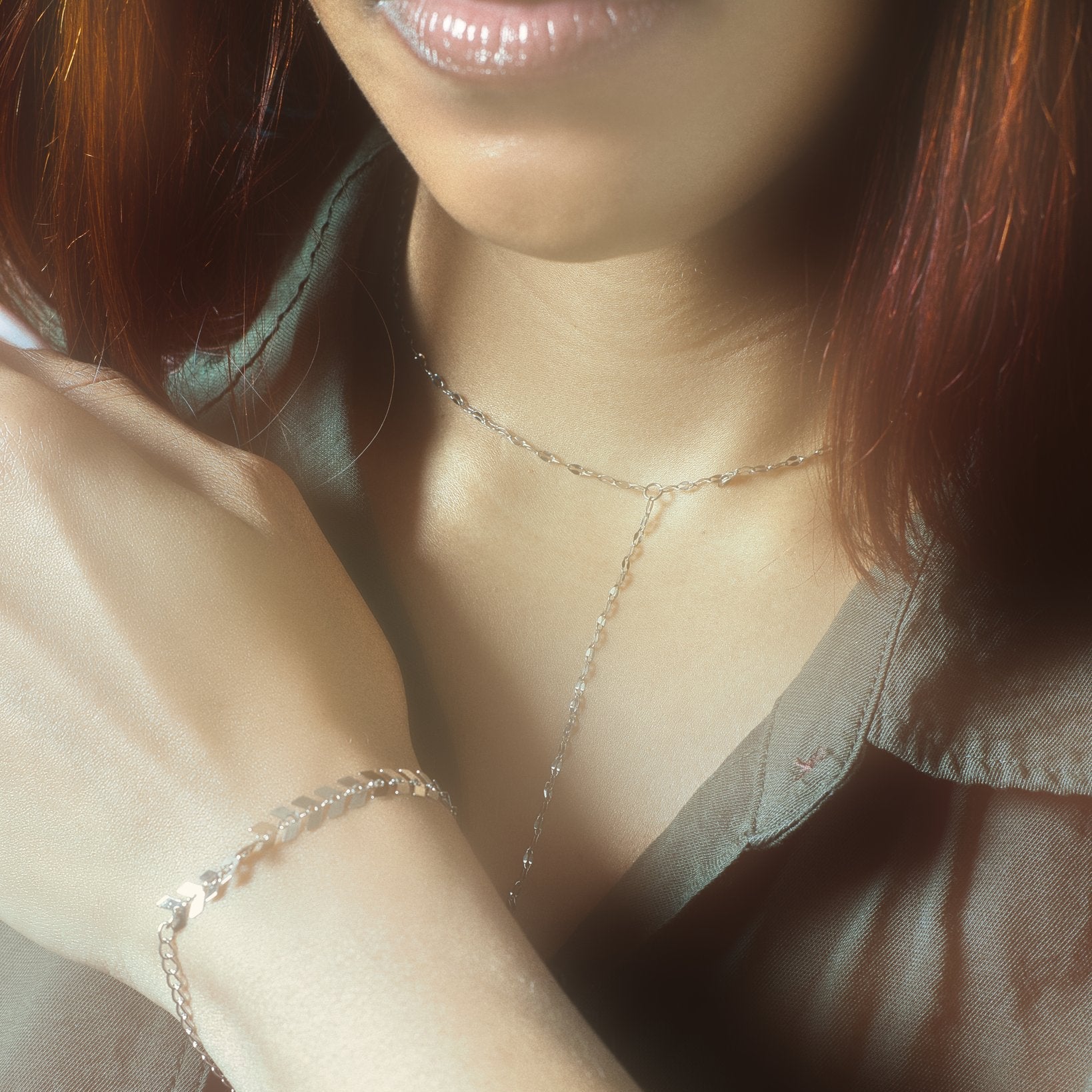 Silver Y-lariat necklace and reflective disc chain bracelet styled on model – hypoallergenic stainless steel jewelry that’s waterproof, tarnish-resistant, and perfect for minimal everyday elegance.