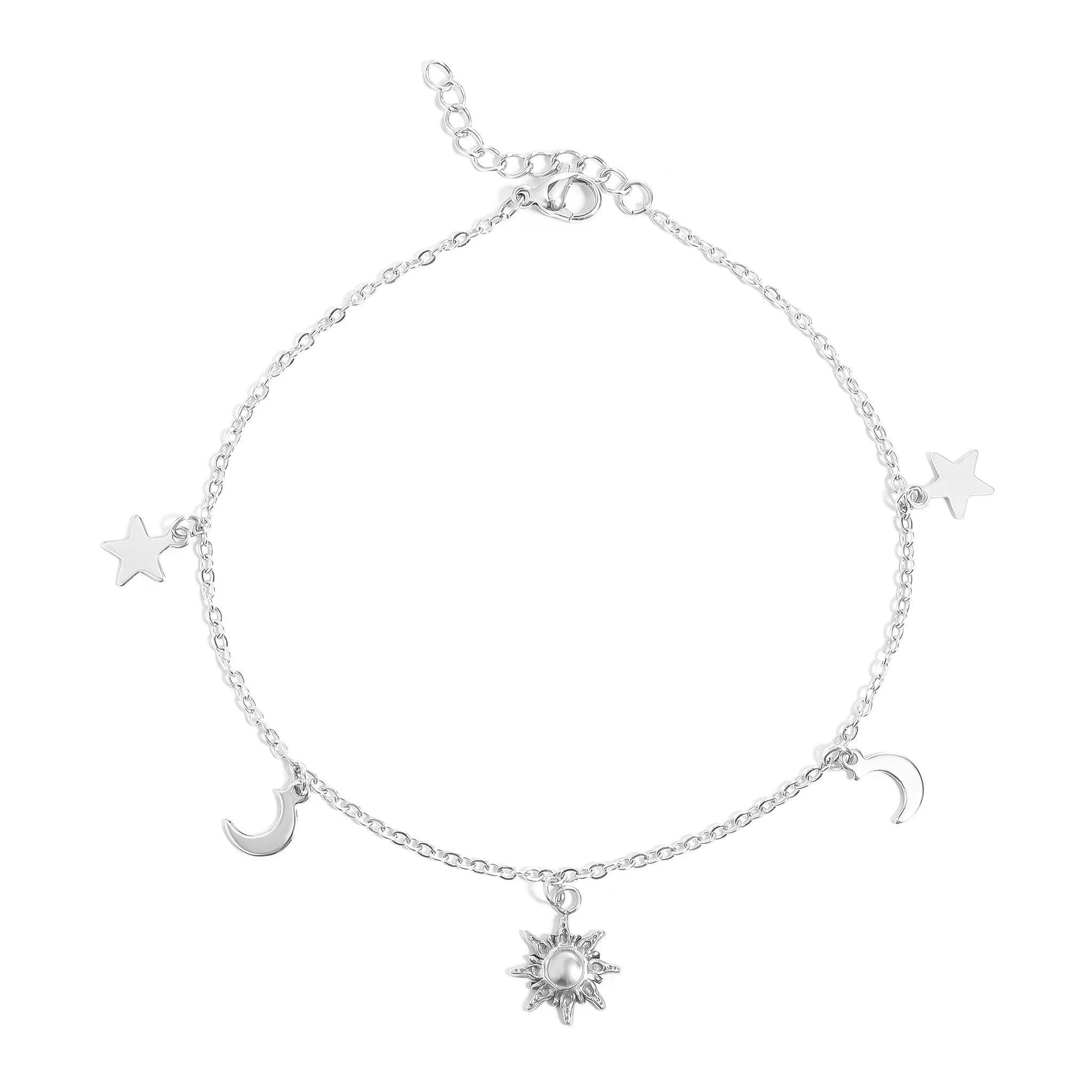 Silver celestial anklet featuring sun, moon, and star charms – dainty and adjustable ankle bracelet for women, perfect for beachwear and everyday outfits