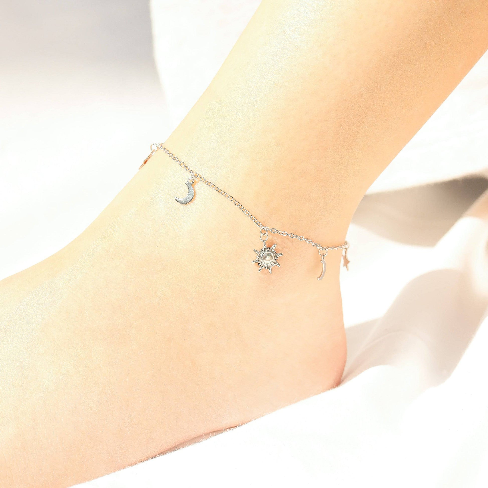 Silver celestial charm anklet with sun, moon, and star details – delicate and elegant ankle bracelet for women, perfect for minimalist summer fashion and beachwear accessories