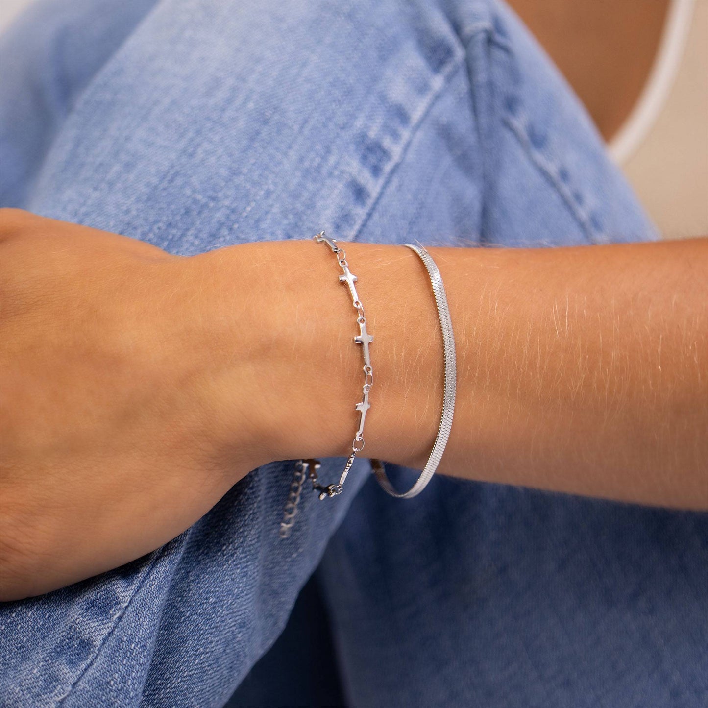 Minimalist silver cross link bracelet stacked with sleek bangle. Waterproof, tarnish-free, and hypoallergenic—perfect for casual, layered looks.